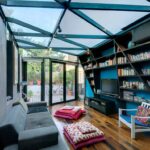 Small-contemporary-home-library-with-glass-roof-blue-walls-and-innvotaive-design-17403